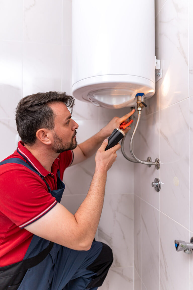 man repairs water heater at home during daylight h 2026 01 09 12 12 34 utc 1 scaled.jpg